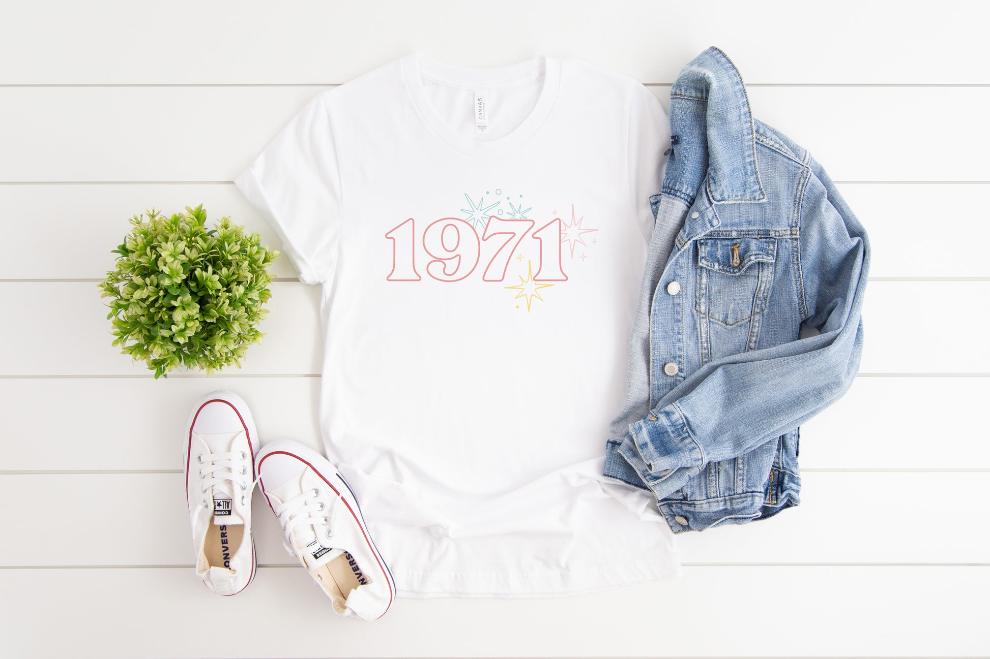 White t-shirt with 1971 text and starbursts to celebrate Disney World's 50th anniversary.