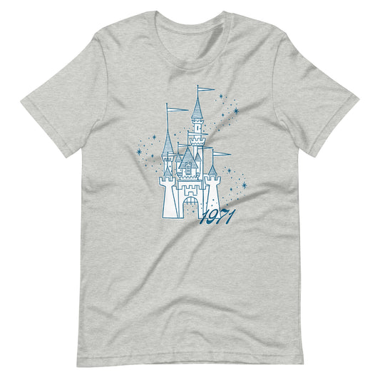 Gray shirt printed with vintage style sketch of a castle, the year 1971, and pixie dust around the castle.