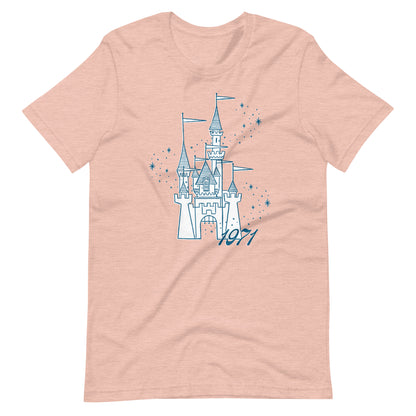 Peach shirt printed with vintage style sketch of a castle, the year 1971, and pixie dust around the castle.