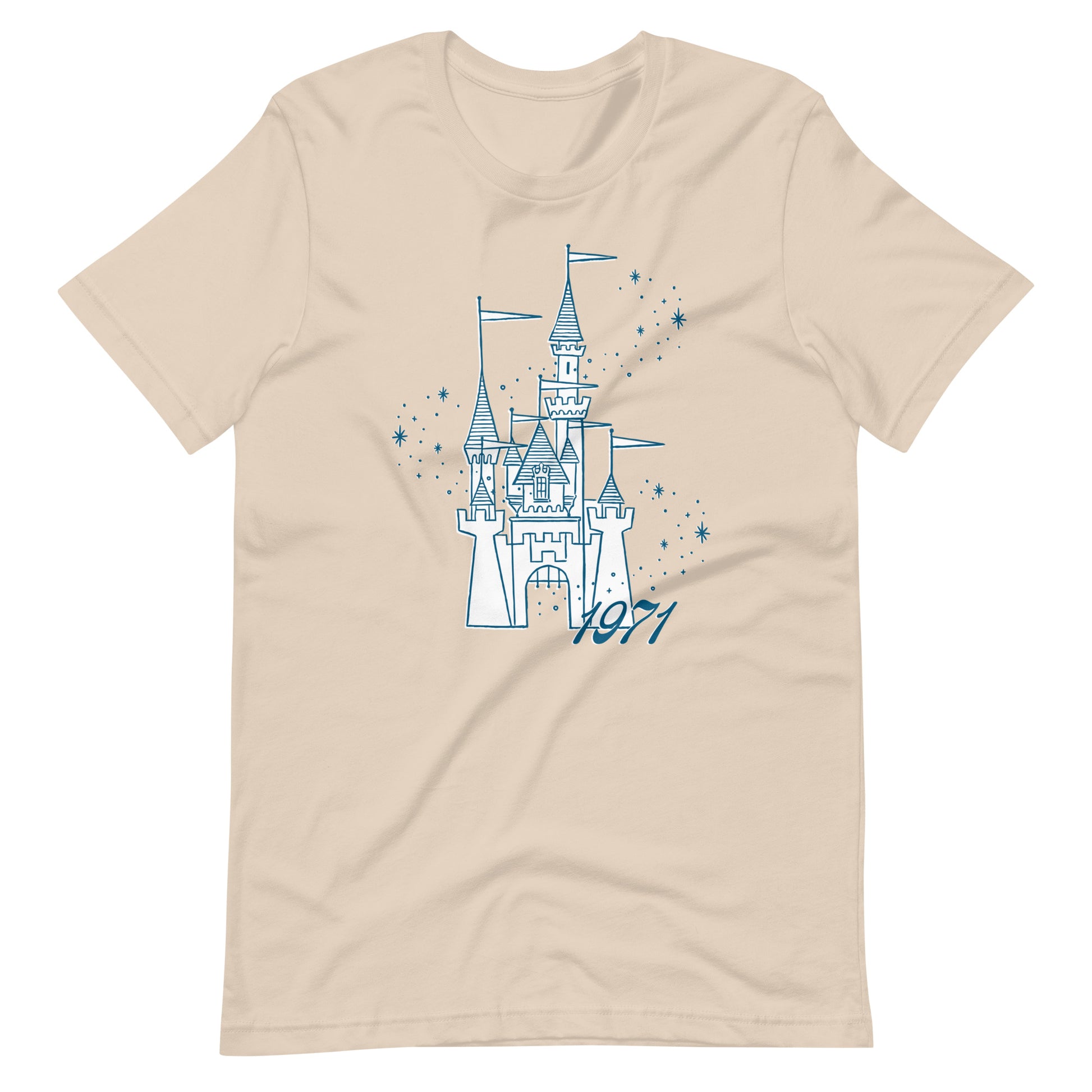 Cream shirt printed with vintage style sketch of a castle, the year 1971, and pixie dust around the castle.
